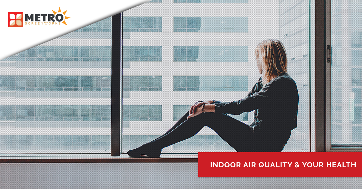 Woman looking out a window and text "indoor air quality & your health"