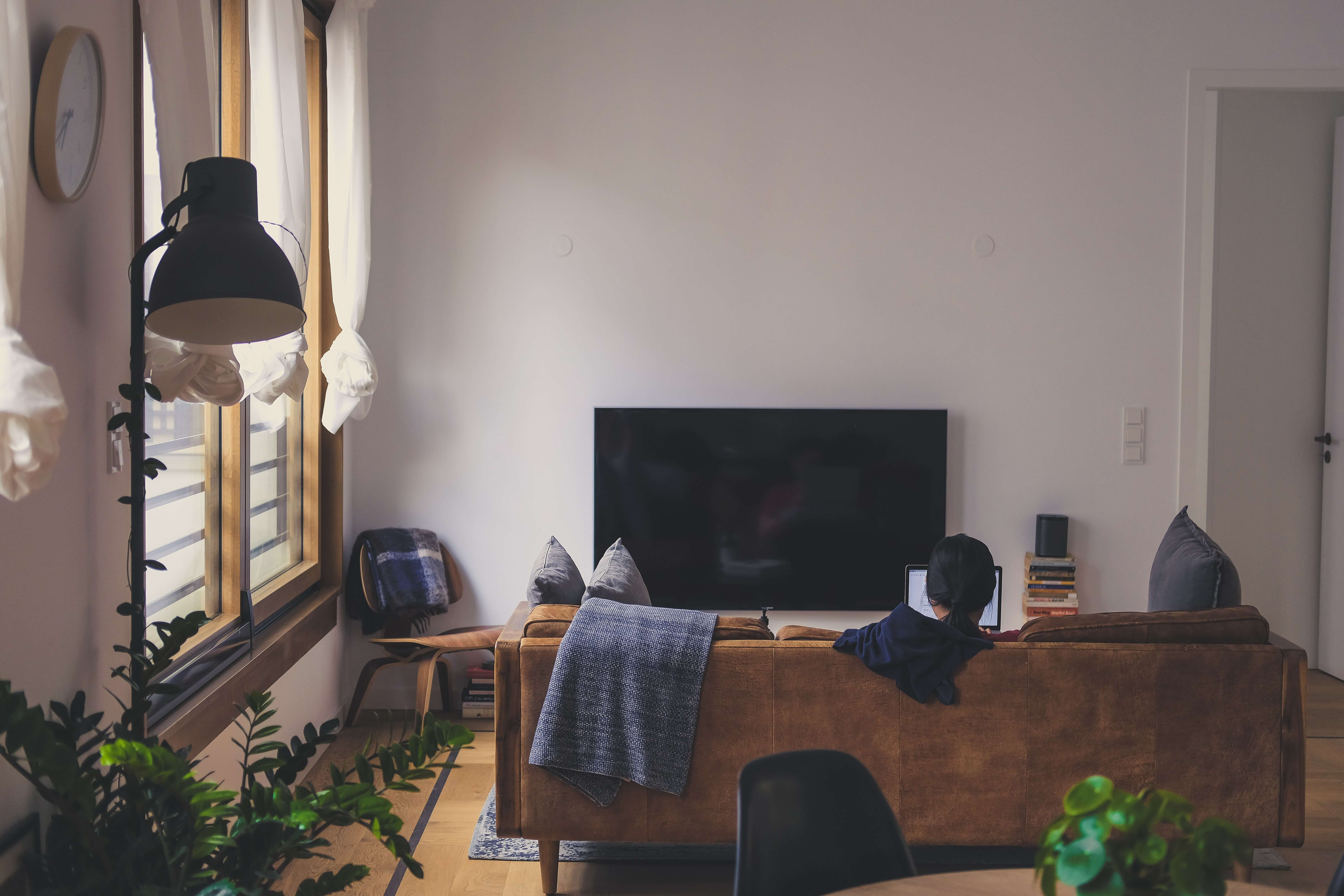 Man lounging in shaded living room