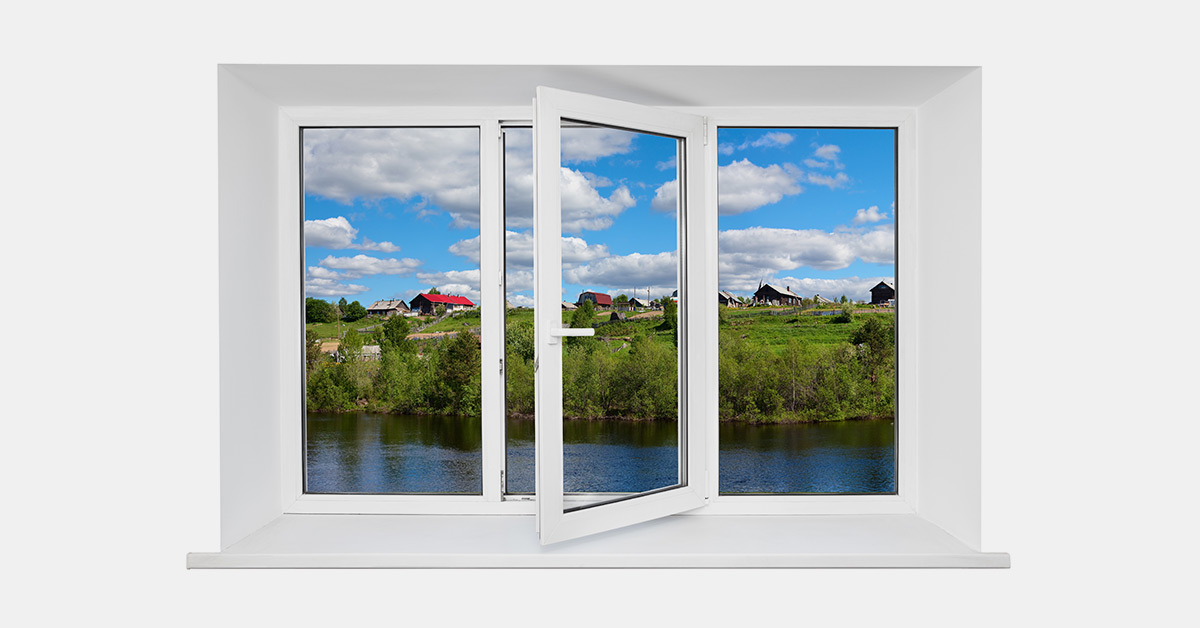 Tilt and turn window overlooking a river and field