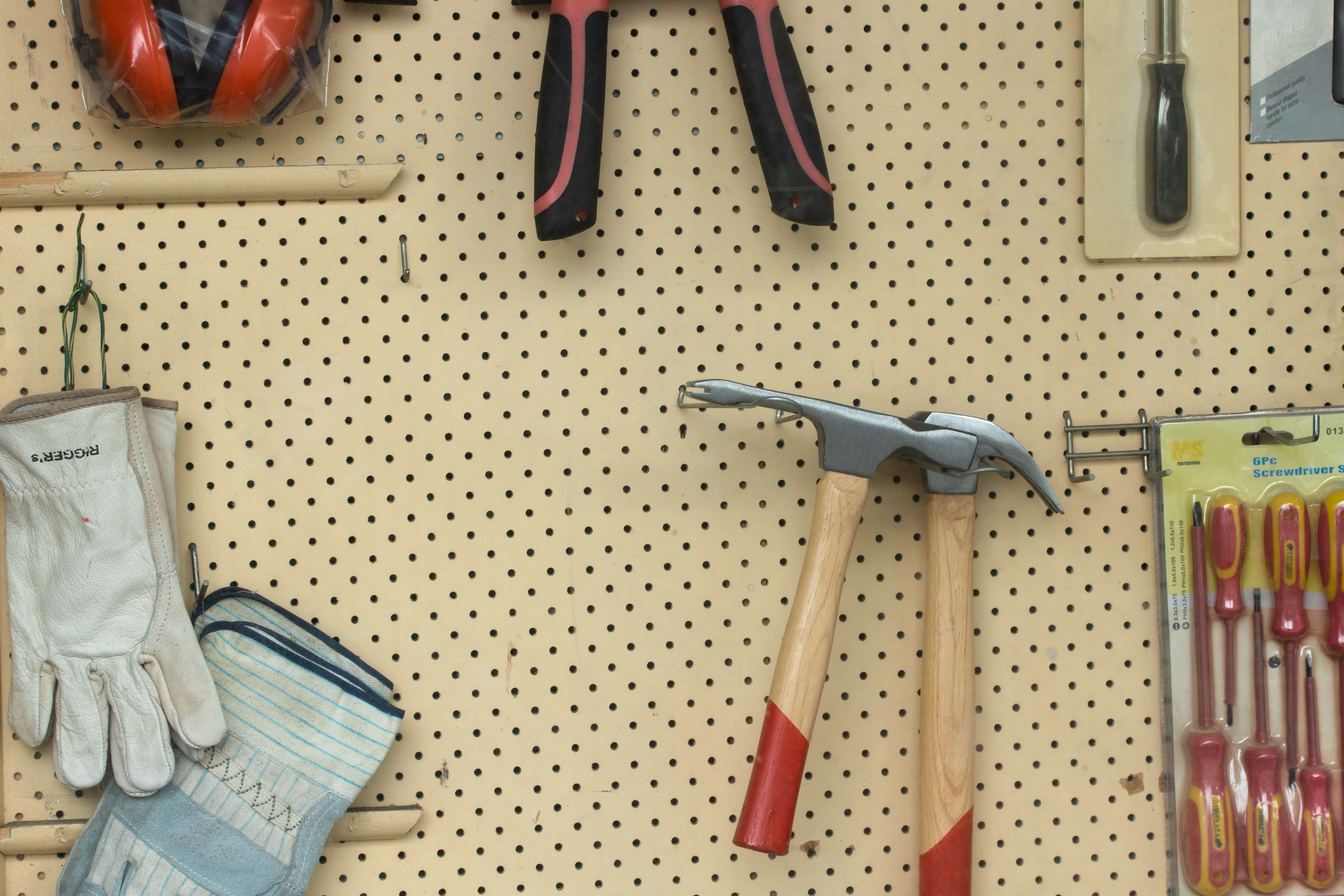 Cork board with tools hanging from hooks