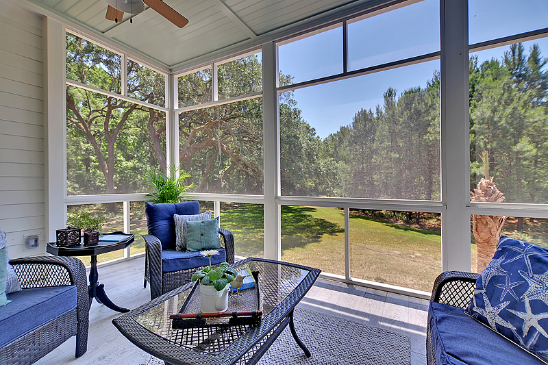 Screened in porch with blue furniture