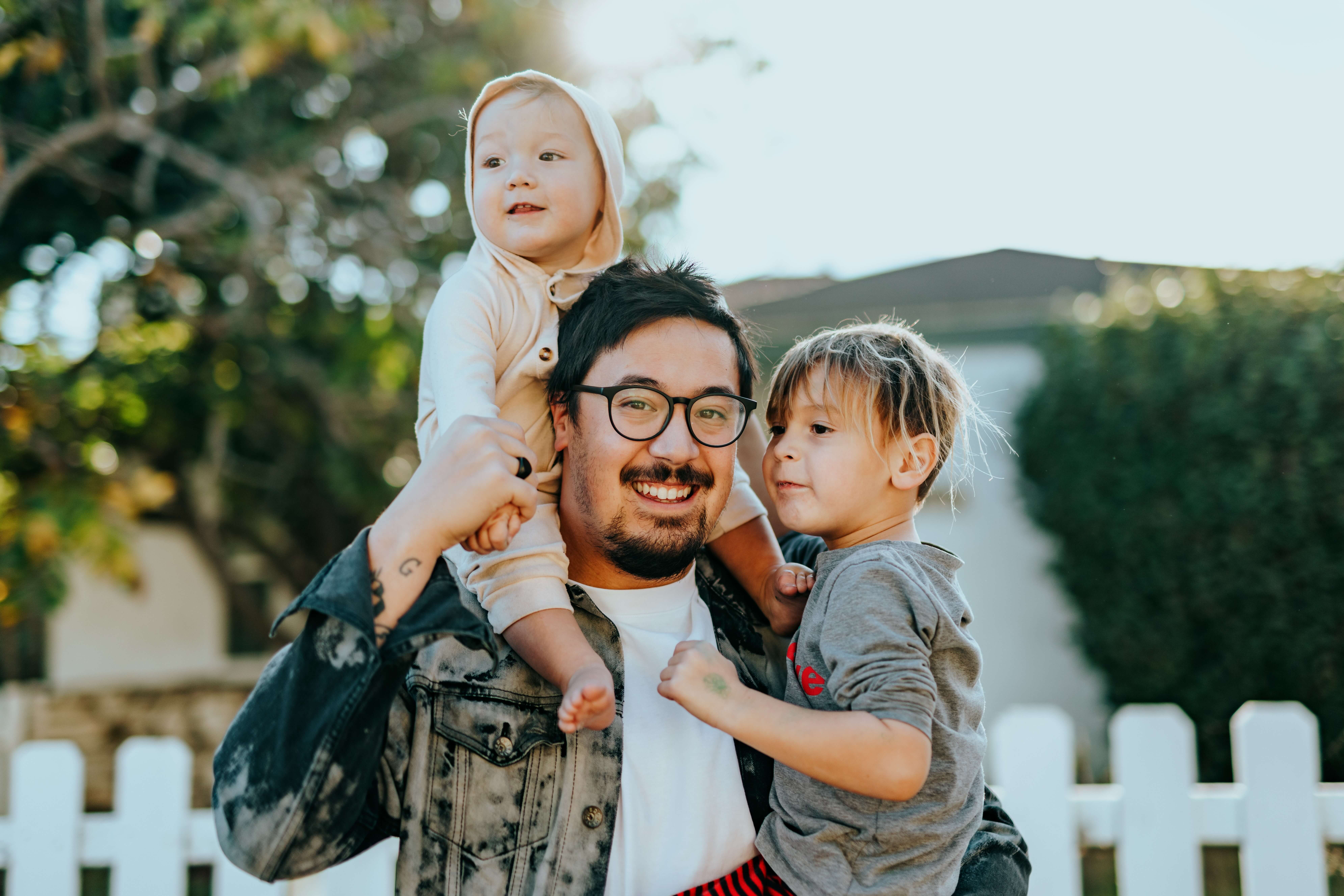 Man holding two children