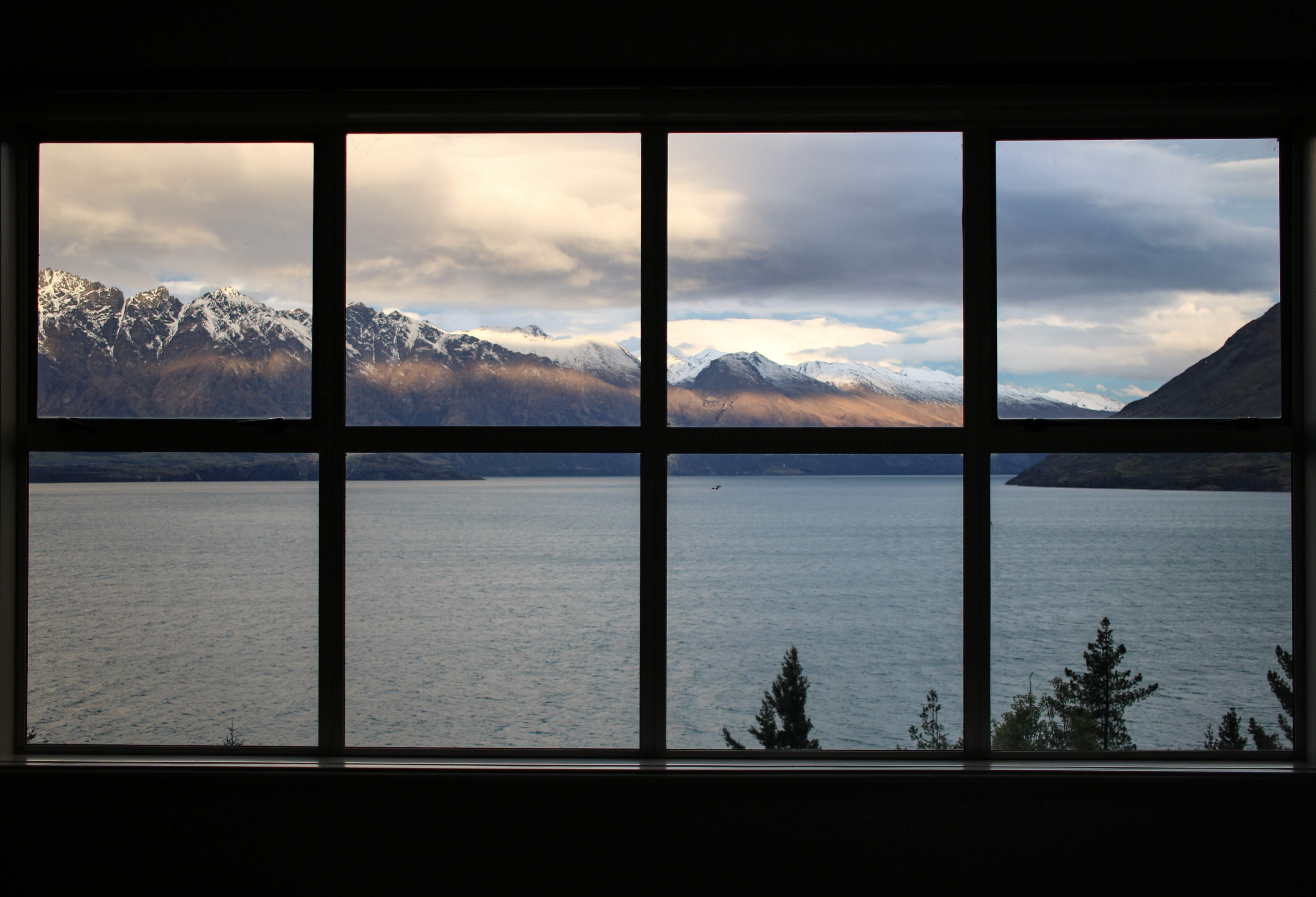 Window overlooking mountains and a lake