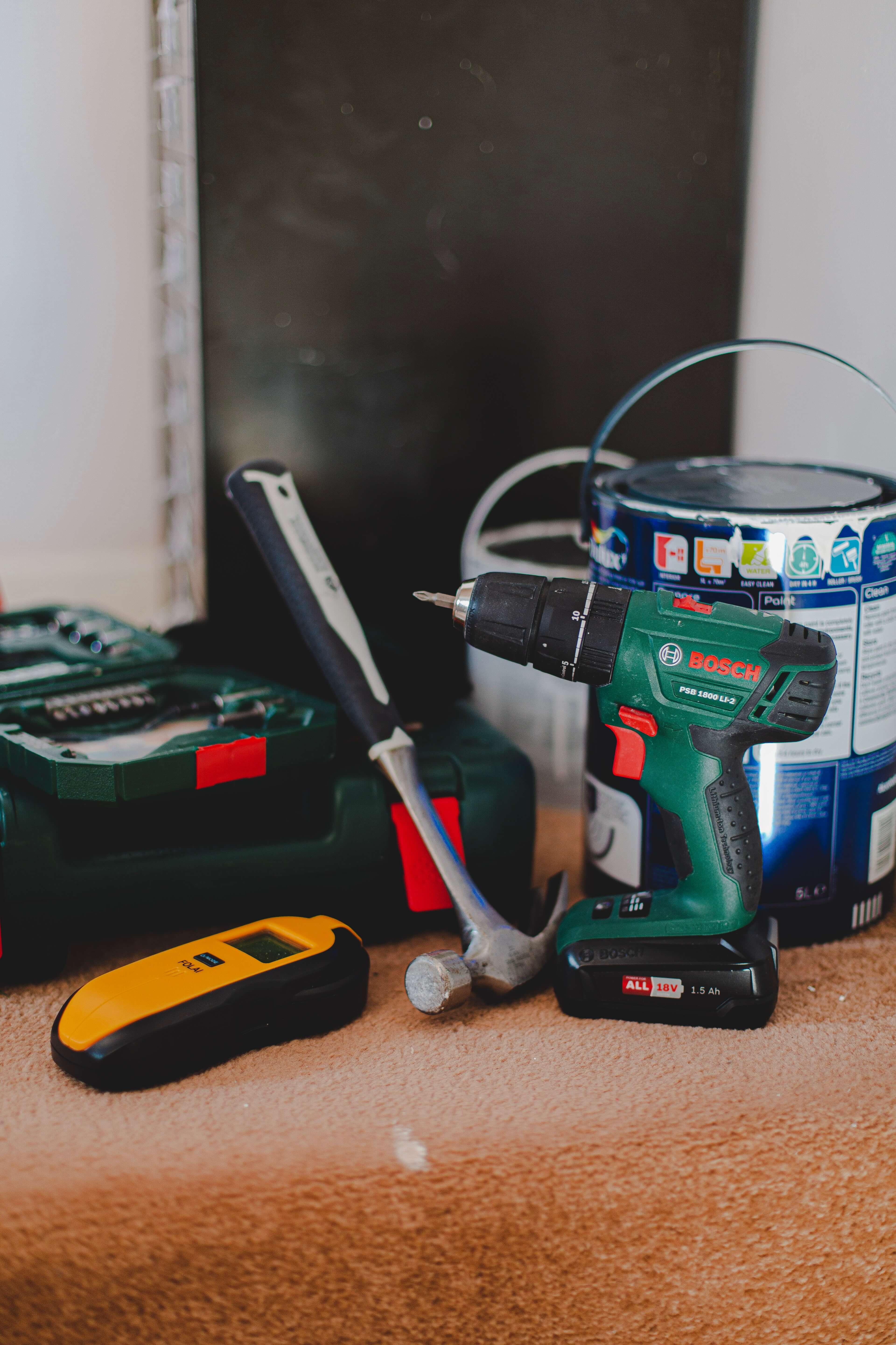 Power tools and a paint can on a workbench