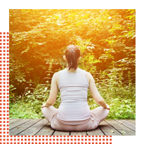 Woman meditating by a tree